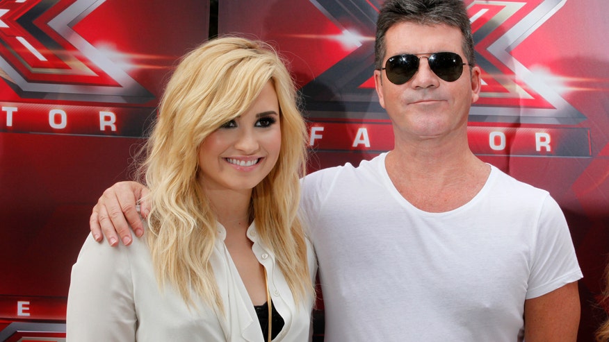 cowell and lovato reuters.jpg